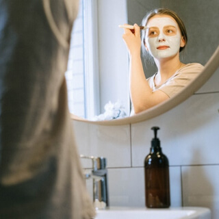 Skincare routine by a mirror