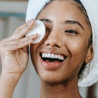 Woman cleansing her face